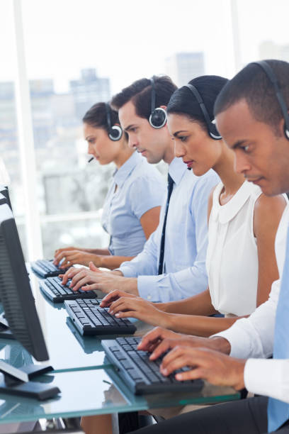 istock Call center employees sitting in line 849525332