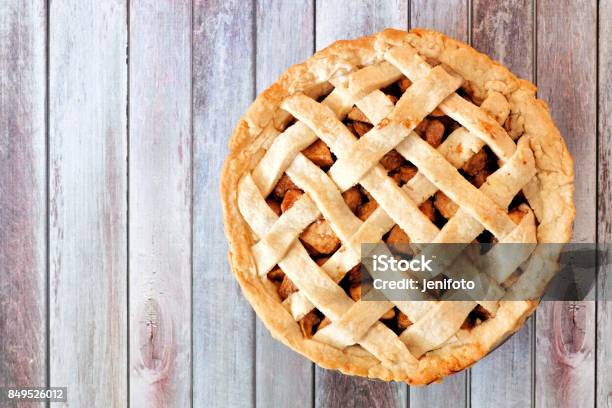 Homemade Apple Pie With Lattice Pastry Over Aged Wood Stock Photo - Download Image Now