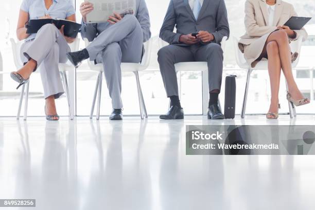 Group Of Well Dressed Business People Waiting Stock Photo - Download Image Now - Newspaper, Reading, 20-24 Years