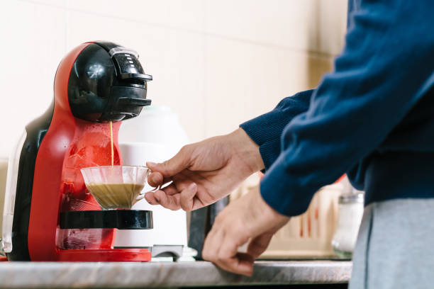 Start day with a good coffee Man making coffee with coffee maker coffee maker stock pictures, royalty-free photos & images