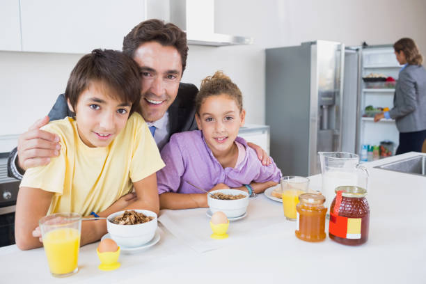 istock Happy father and children at breakfast 849546290