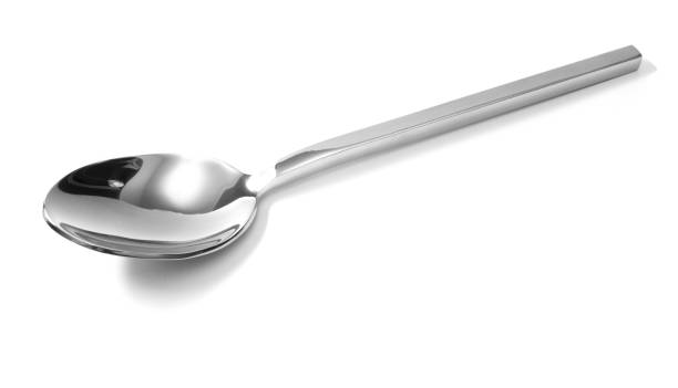 istock Stainless steel glossy metal kitchen spoon isolated over the white background 849551836