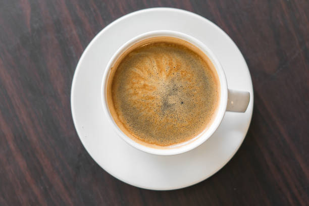 istock hot coffee latte art on wood table background 849555310