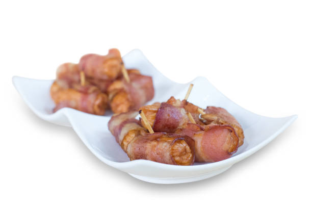 istock Deep fried sausages rolled in bacon isolated on white background 849559056