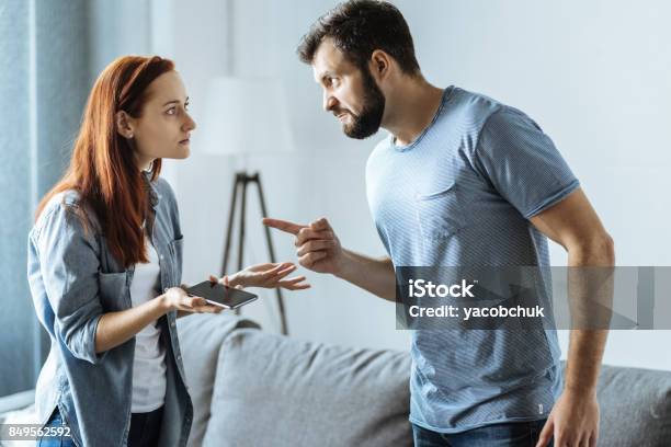 Angry Upset Man Pointing At His Wife Stock Photo - Download Image Now - Arguing, Couple - Relationship, Conflict