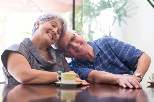 Senior adult couple drinking tea stock photo