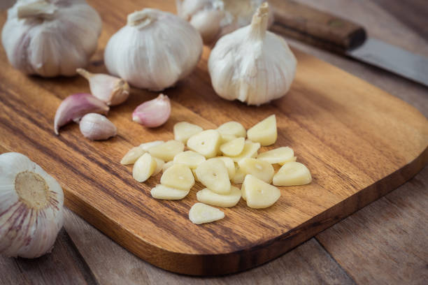 istock Garlic on wooden cutting board 849570716