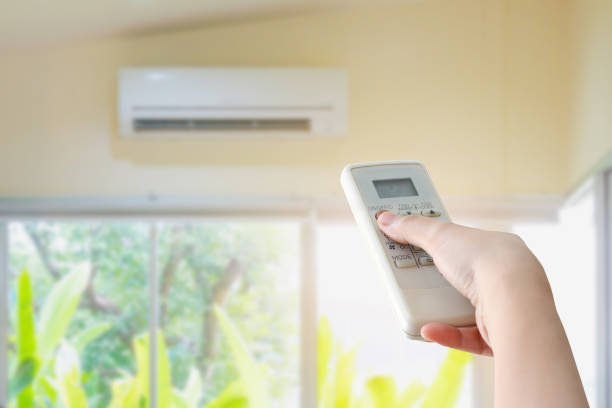 istock Hand hold remote control directed on the air conditioner 849575046