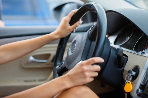 istock close up of woman's hands holding steering wheel 849578450
