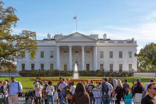 Washington D.C., USA, october 29, 2016: Tourists in front of the White House. It is the official residence and principal workplace of the President of the United States.