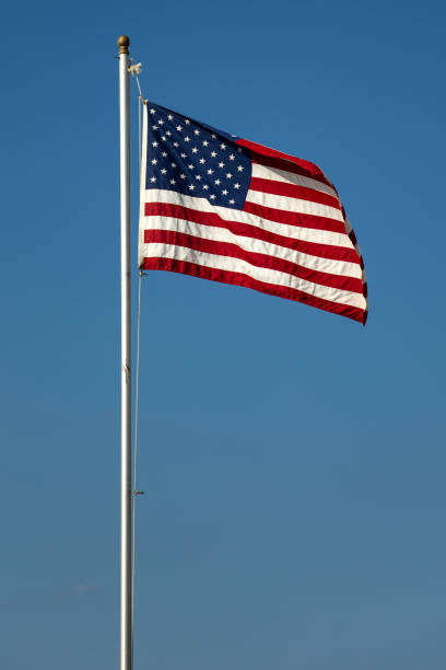 istock American flag on the blue sky 849583086