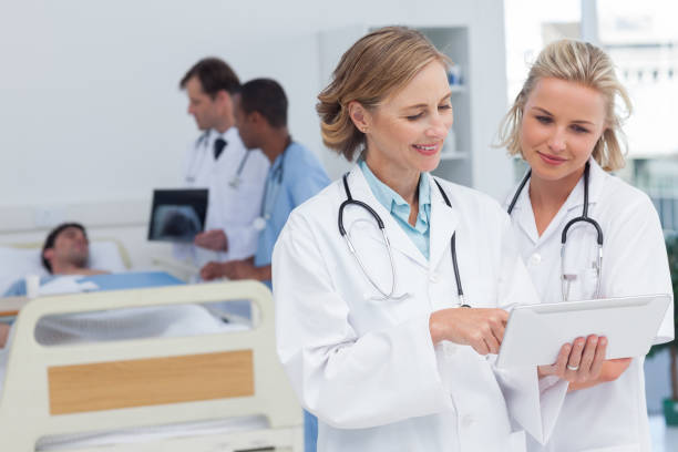 istock Two women doctors looking at tablet 849583198