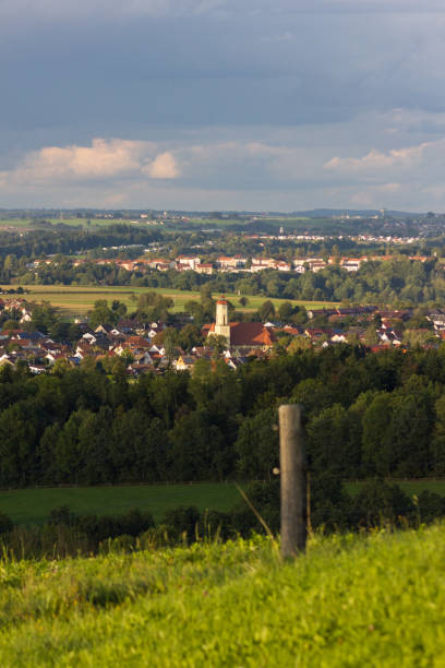 istock pasture fence with village in background 849593494