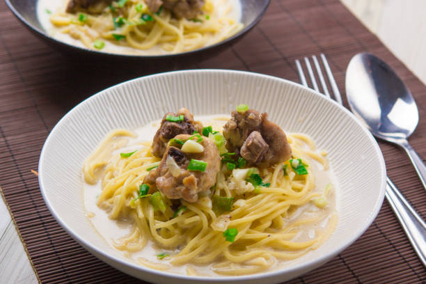 istock Chicken spaghetti alfredo pasta on wood background 849599306