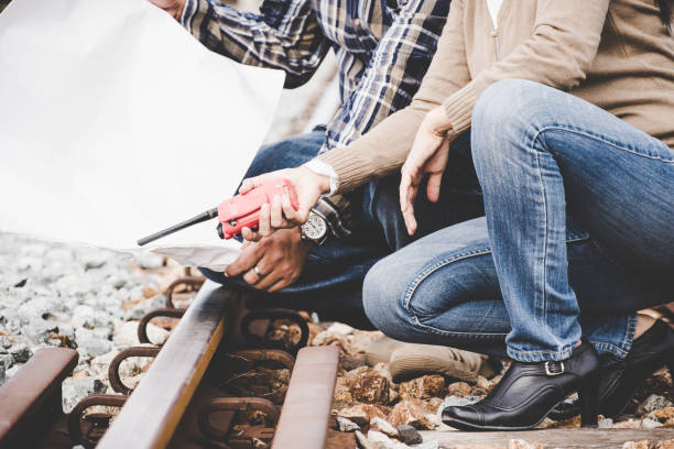 istock Railroad engineer women with workers hold blue pint and white helmet checking railways for civil and construction site.  Engineer Concept 849607066