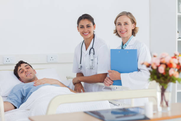 istock Two doctors and a patient looking at the camera 849614418