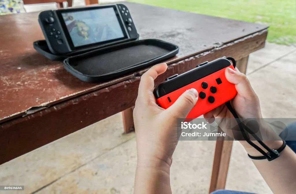 editorial of close up kid hold joystick playing game Video Game Stock Photo