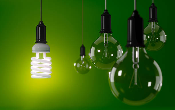 istock Energy Saving Light Bulb Standing Out From The Crowd Over Green Background: Energy Efficiency and Standing Out From The Crowd Concept 849625634