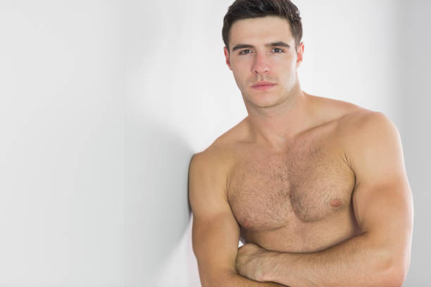 istock Stern handsome man leaning topless against wall 849625854