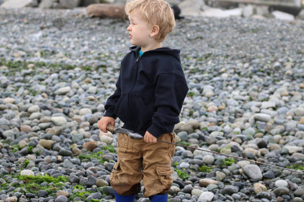 istock Young Boy Fishing in Pacific Ocean 849633384