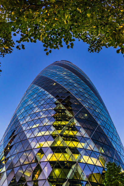 istock London’s iconic Gherkin tower framed by green tree overhang 849636470