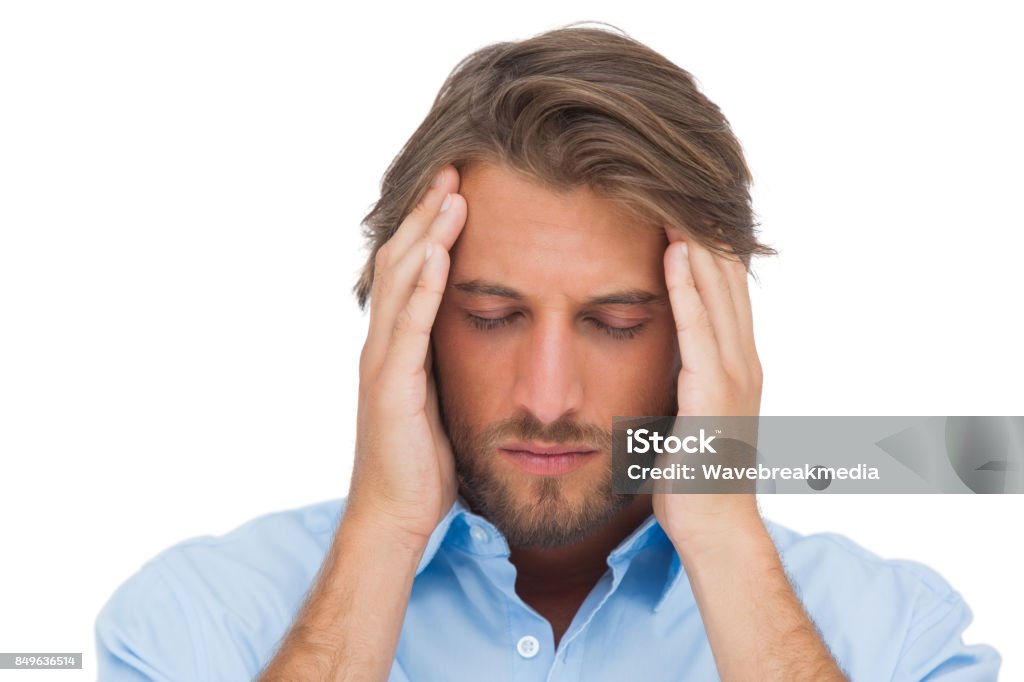 Handsome man touching his temples to calm a headache Handsome man touching his temples to calm a headache on white background 20-29 Years Stock Photo