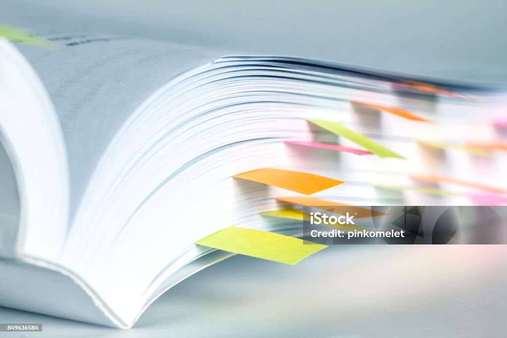 Close up White book marked by sticky note Handbook Stock Photo