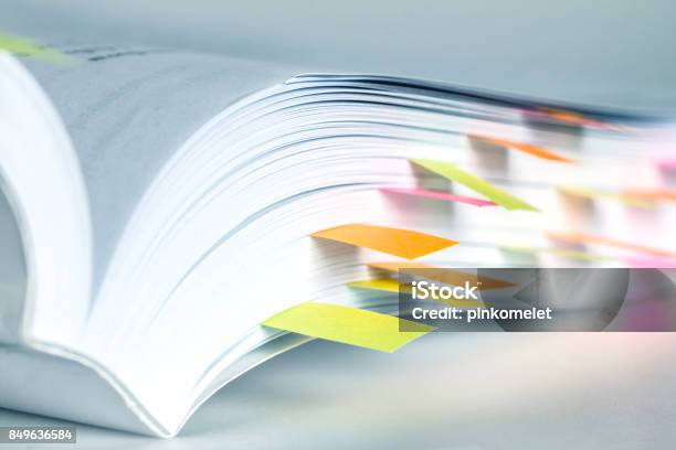 Close Up White Book Marked By Sticky Note Stock Photo - Download Image Now - Handbook, Instruction Manual, Instructions