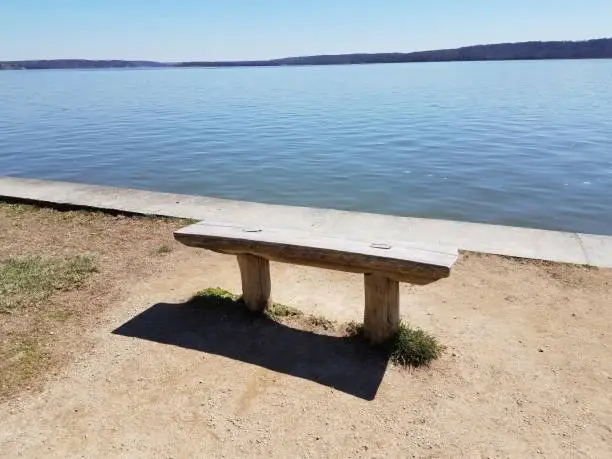 a wooden bench along the Potomac river in Virginia and Maryland