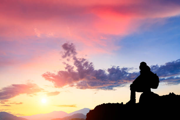 istock Silhouette of a man on the mountain at sunset 849656928