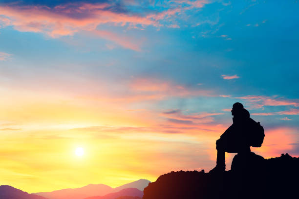 istock Silhouette of a man on the mountain at sunset 849659854