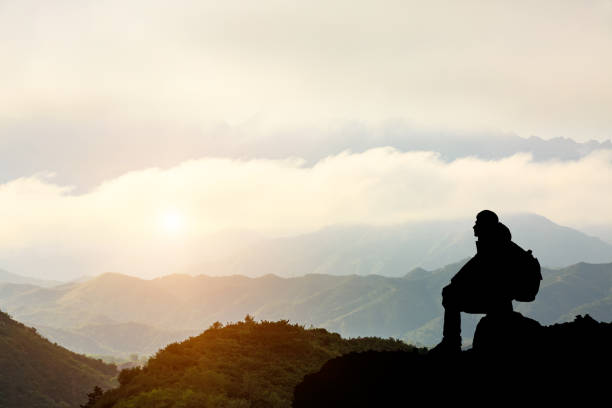 istock Silhouette of a man on the mountain at sunset 849660128