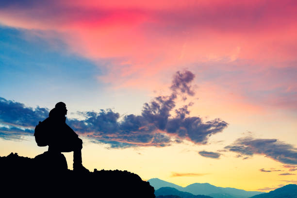 istock Silhouette of a man on the mountain at sunset 849660240