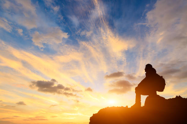 istock Silhouette of a man on the mountain at sunset 849660280