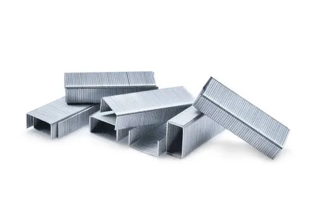 Photo of pile of metal staples isolated on white background