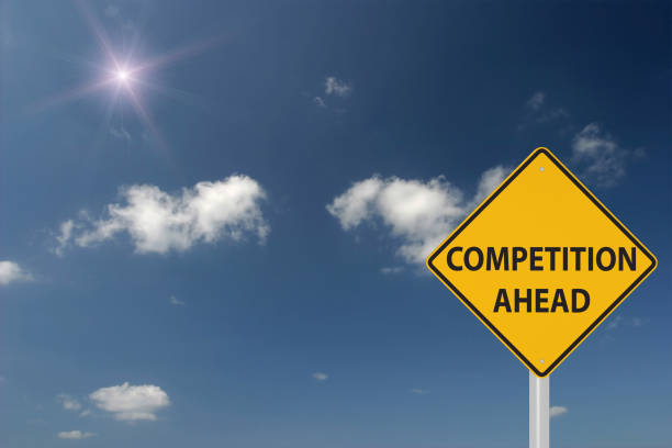 Competition ahead warning sign concept stock photo