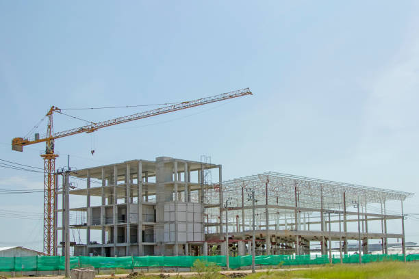 istock Crane lift with factory under construction. 849673734