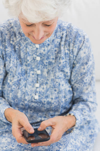 istock Elderly smiling woman using a smartphone 849676180