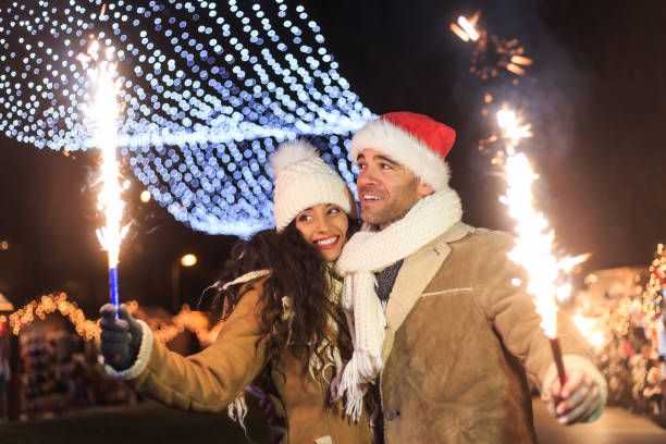 istock Young couple having fun with sparkling candles at night 849676312