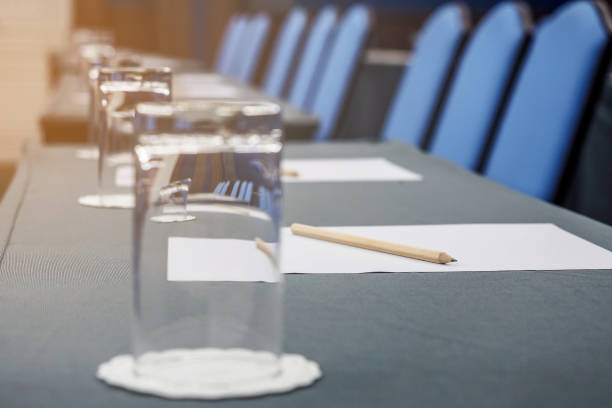 istock Conference hall Interior with table, raw of chairs and block-notes 849679614