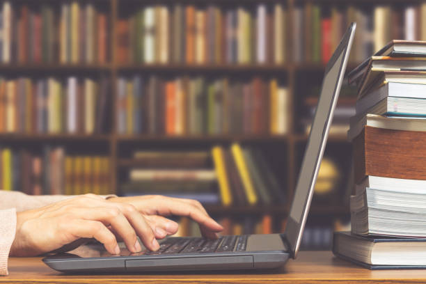 istock male student hands making research on laptop and browse internet for preparing exam and learning lessons in library 849683940