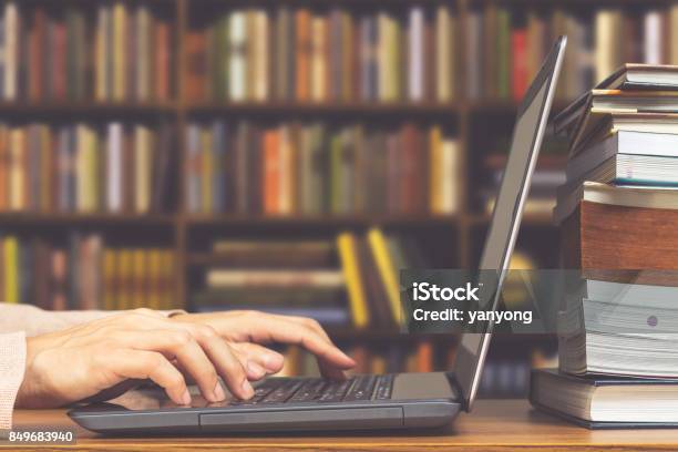 Male Student Hands Making Research On Laptop And Browse Internet For Preparing Exam And Learning Lessons In Library Stock Photo - Download Image Now