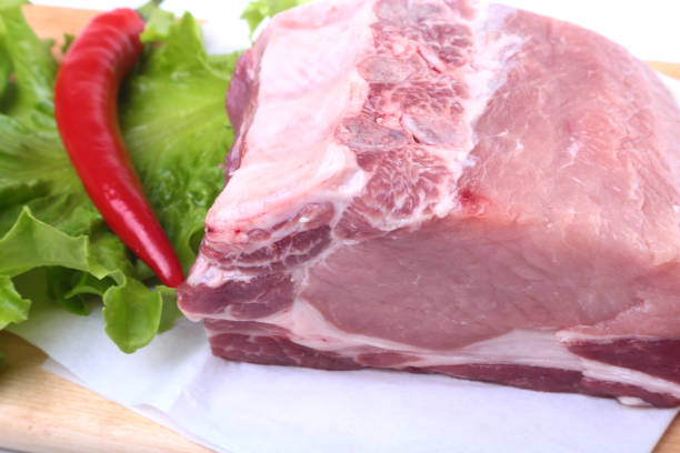 istock Raw pork chops with herbs and spices on cutting board. Ready for cooking. 849684170