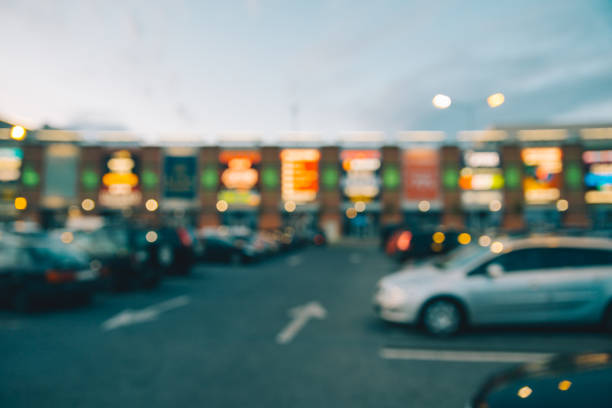 Blurred view of parking in front of mall stock photo