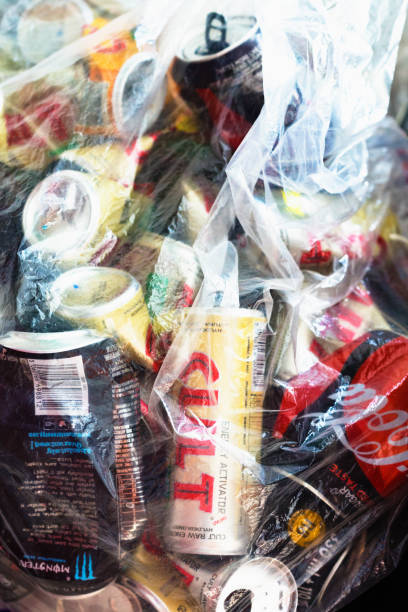 Soft drink cans for recycling in plastic bag Cape Town, South Africa - September 13, 2017: A variety of soft-drink cans inside a clear plastic bag, about to be taken to a recycling depot. monster energy stock pictures, royalty-free photos & images