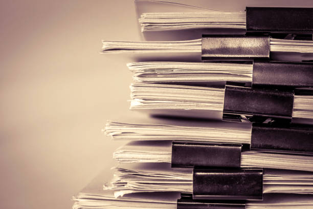 istock extreamly close up the stacking of office working document with paper clip folder, vintage color tone 849687858