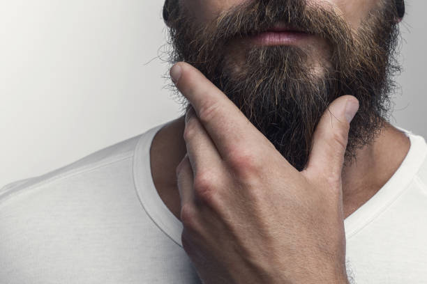 Touching his great beard Touching his great beard facial hair stock pictures, royalty-free photos & images