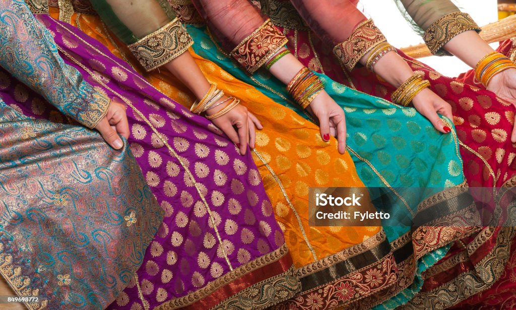 Bollywood dancers dress Bollywood dancers are holding their vivid costumes. Hands are in a row India Stock Photo