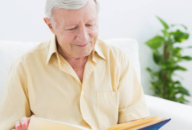 istock Elderly smiling man watching his album 849699156