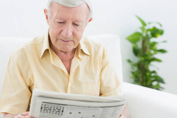 istock Elderly calm man reading newspapers 849699220